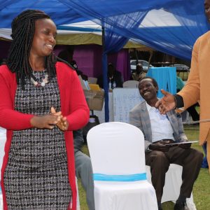 Ann Njuguna being handed over acertificate after being elected as member of National Board by outgoing Deputy General Seceratry David Musumba